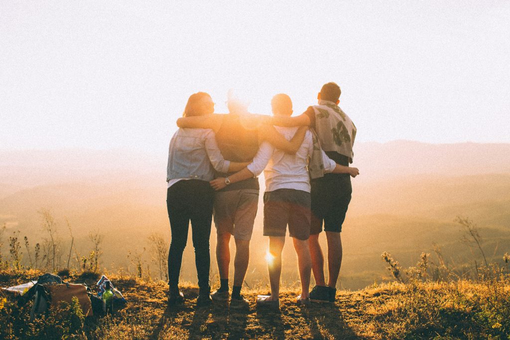 group of people looking towards sunset