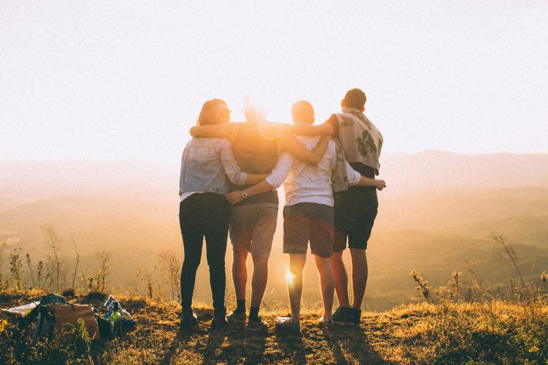 group of people looking towards sunset